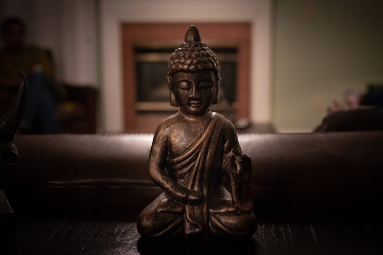 Close-up of a Buddha statue emphasizing tranquility and mindfulness within an indoor setting.